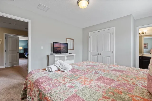 a bedroom with bed and tv