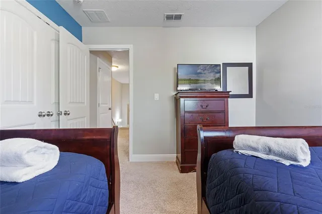 a bedroom with a bed and a dresser