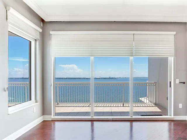an empty room with wooden floor and a window