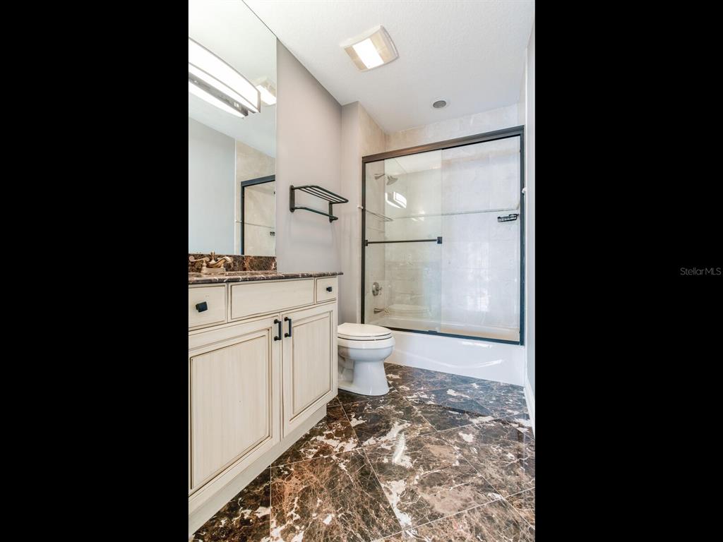 3507 Bayshore Boulevard, Unit 1202 Tampa, FL 33629 - Photo 32 of 68 a bathroom with a sink toilet a mirror and shower