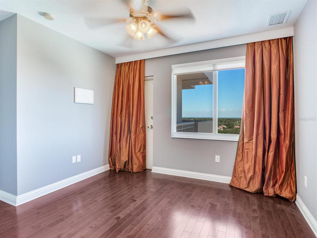 3507 Bayshore Boulevard, Unit 1202 Tampa, FL 33629 - Photo 33 of 68 an empty room with wooden floor and a window