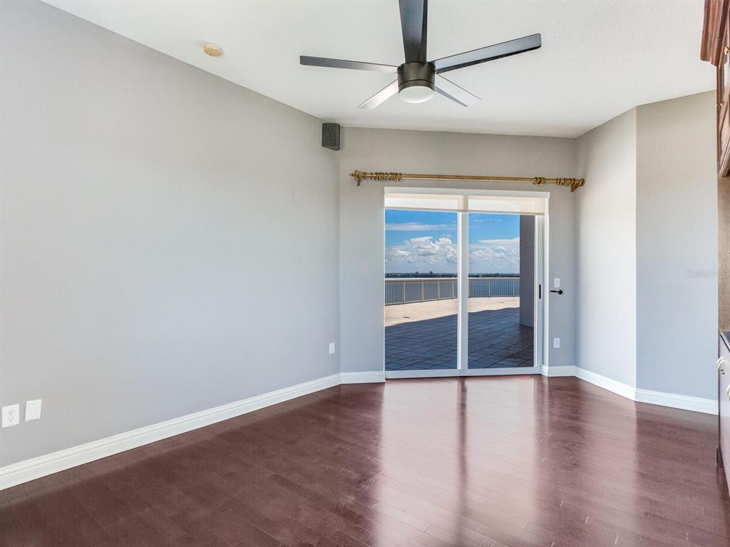 3507 Bayshore Boulevard, Unit 1202 Tampa, FL 33629 - Photo 36 of 68 an empty room with wooden floor and windows