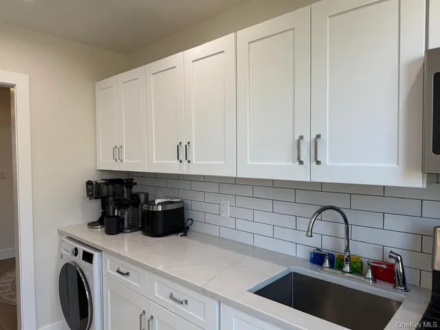 a kitchen with a sink and cabinets