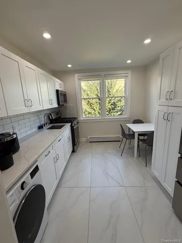 a kitchen with a sink cabinets and window