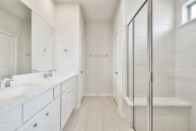 a bathroom with a glass shower door
