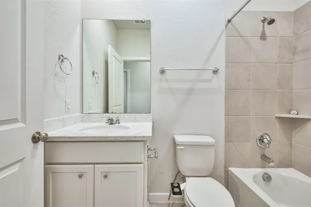 an empty room with chandelier fan