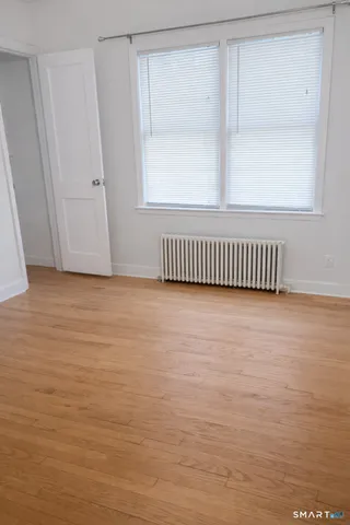 a view of a room with wooden floor and windows