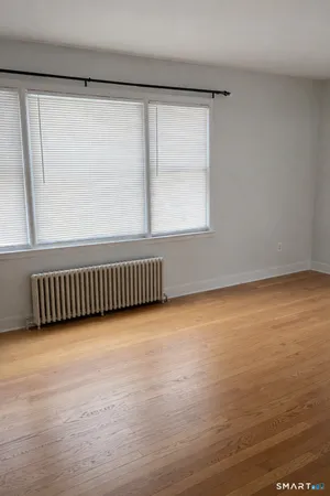 a view of a room with wooden floor and windows