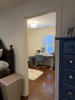 a living room with a bed furniture and a window