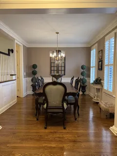 a view of a a dining room with furniture window and wooden floor