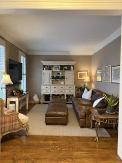 a living room with furniture window and a flat screen tv