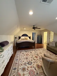 a living room with a couch and a dresser next to a window