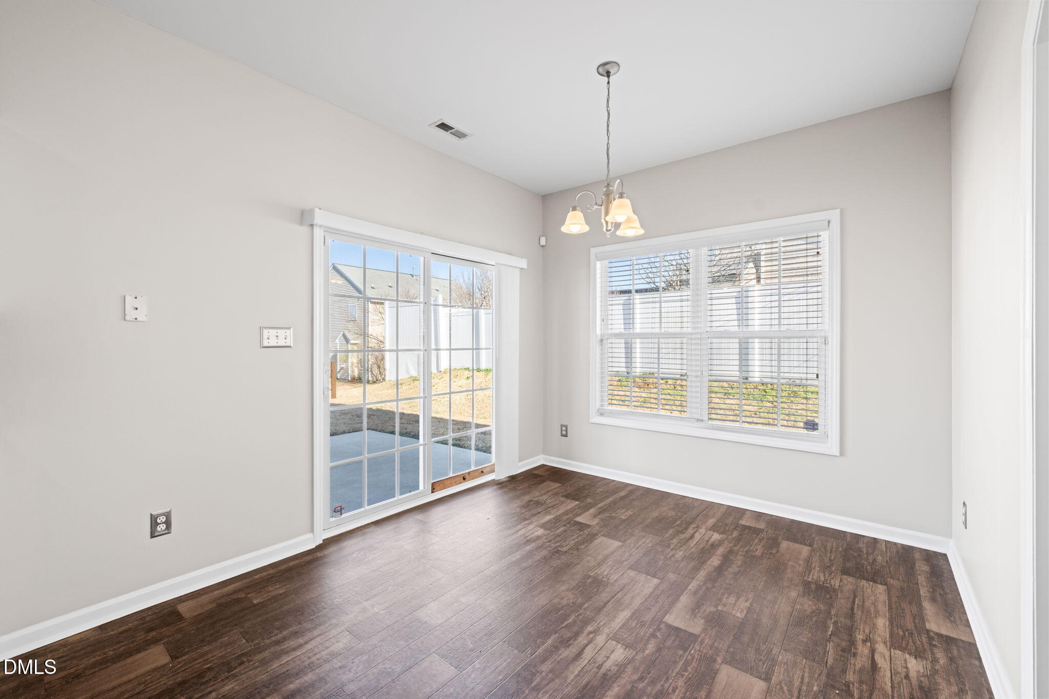 4112 Bay Rum Lane Raleigh, NC 27610 - Photo 10 of 43 a view of an empty room with wooden floor and a window