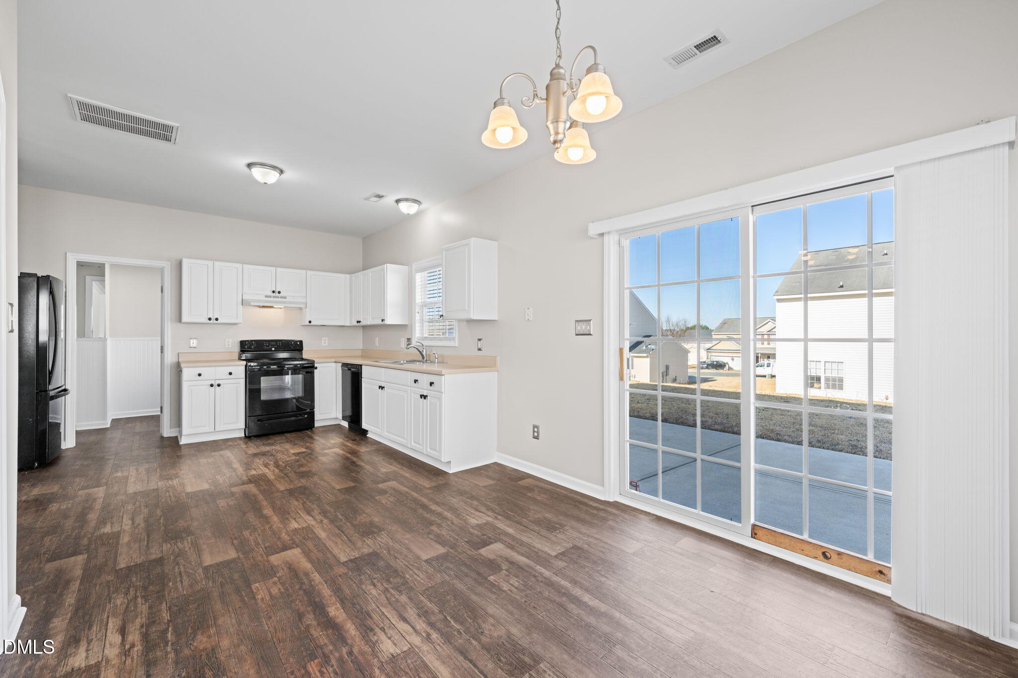 4112 Bay Rum Lane Raleigh, NC 27610 - Photo 14 of 43 a large white kitchen with wooden floor and a sink