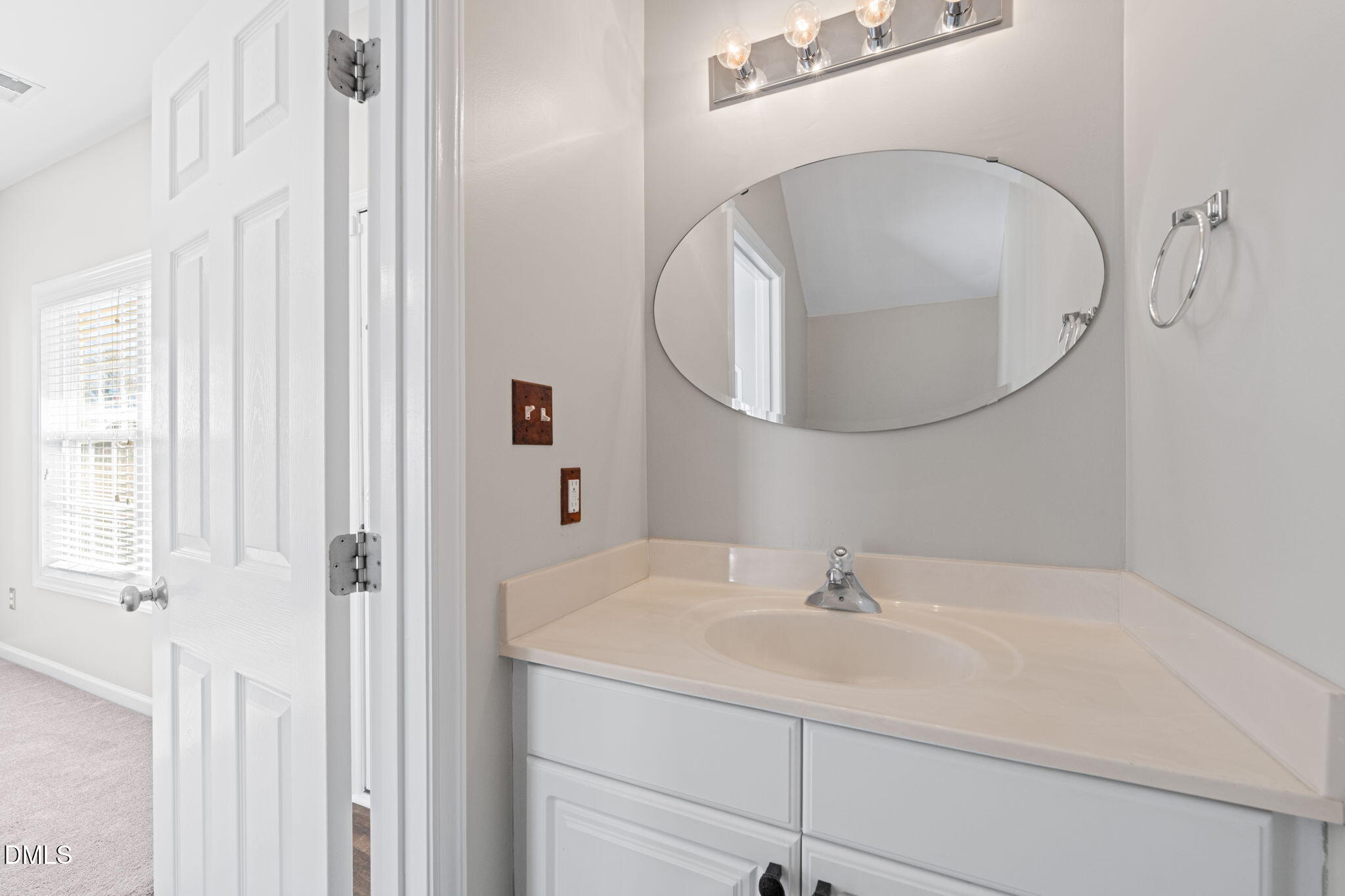 4112 Bay Rum Lane Raleigh, NC 27610 - Photo 19 of 43 a bathroom with a sink a mirror and vanity