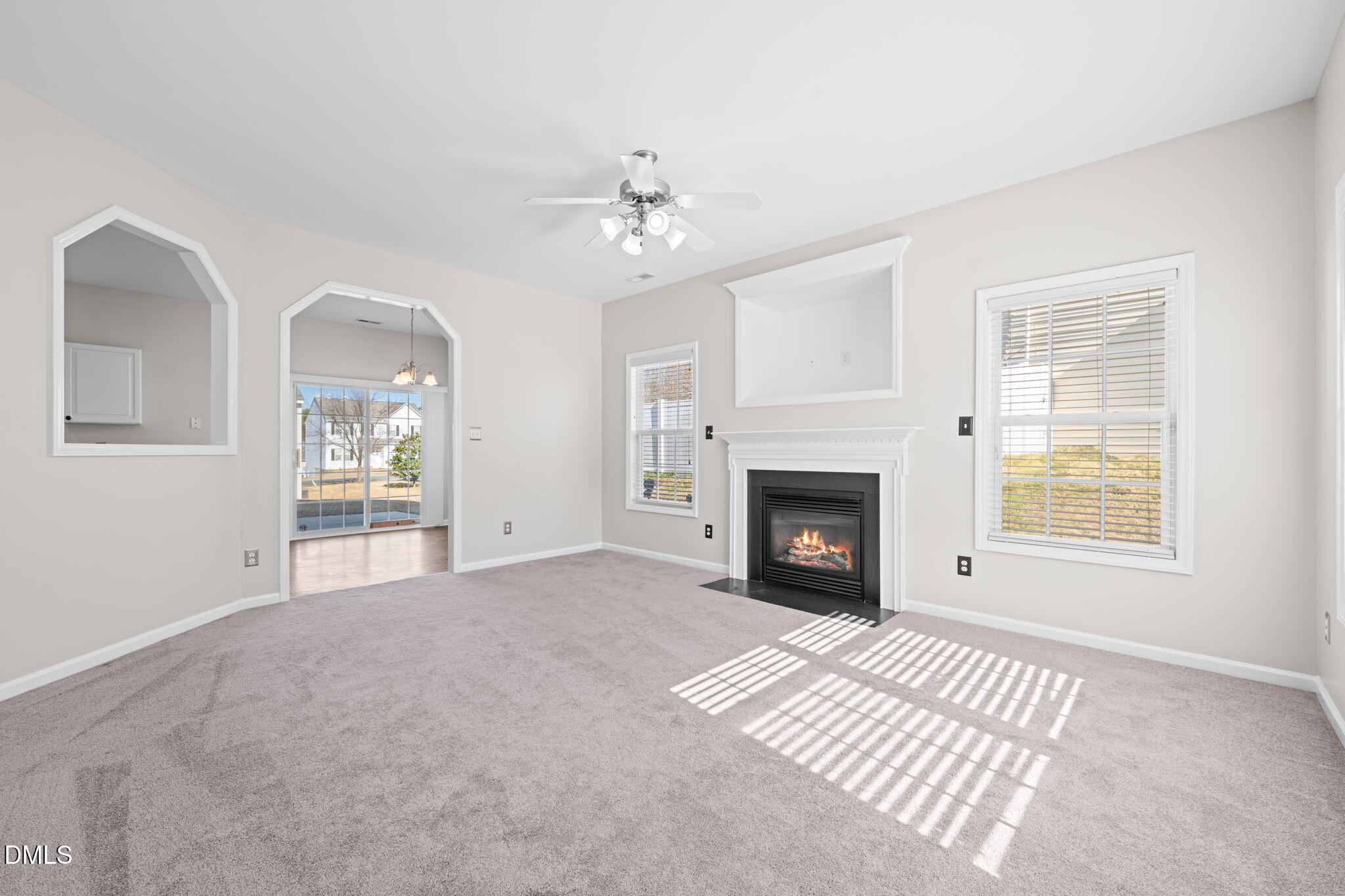 4112 Bay Rum Lane Raleigh, NC 27610 - Photo 5 of 43 a view of an empty room with a window and a fireplace