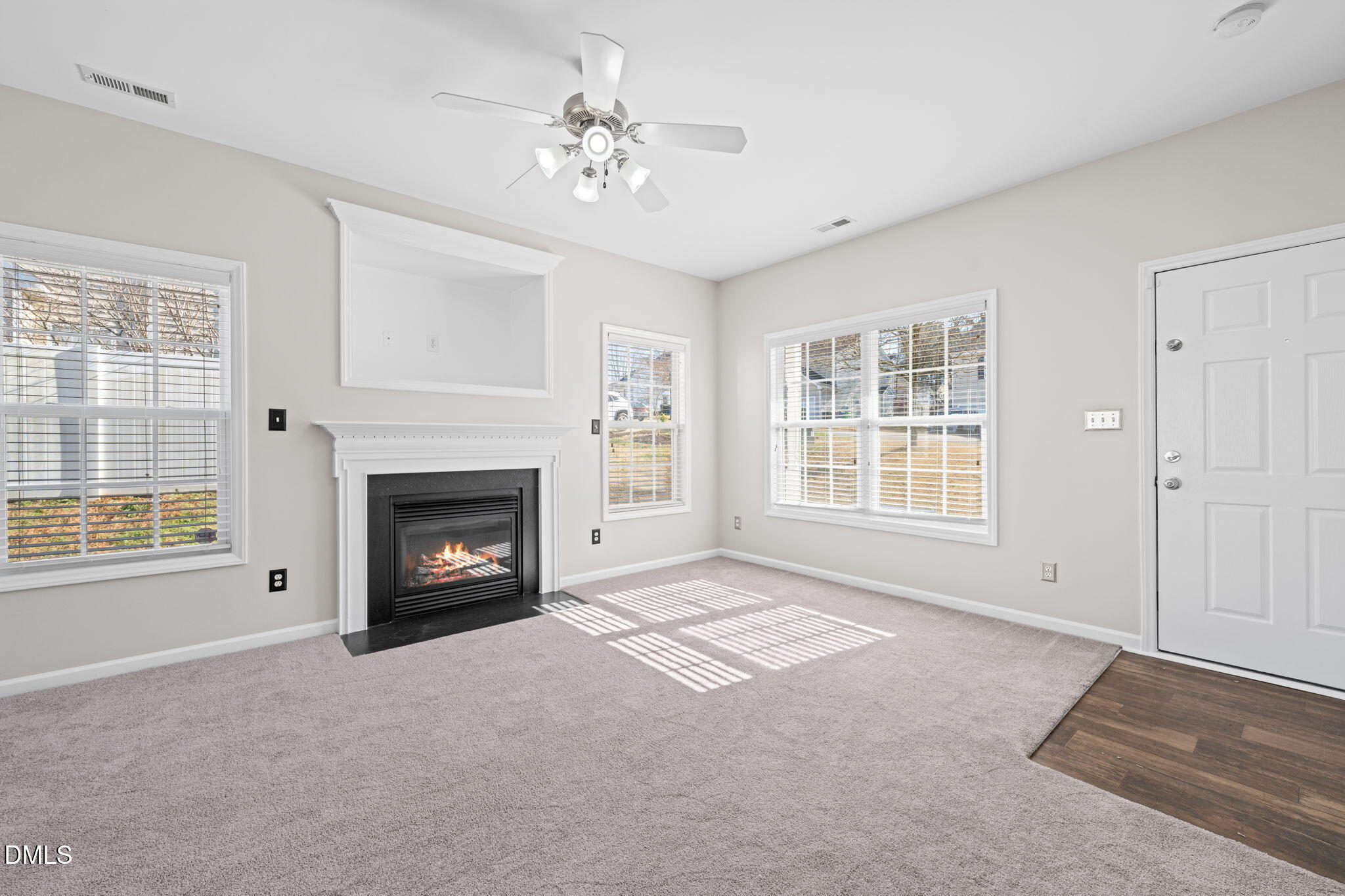 4112 Bay Rum Lane Raleigh, NC 27610 - Photo 7 of 43 a view of an empty room with a fireplace and a window