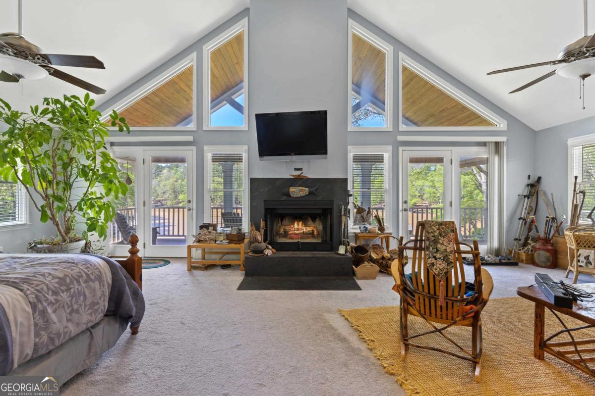 1320 Tal Lewis Road White Plains, GA 30678 - Photo 13 of 19 a living room with furniture a flat screen tv and a fireplace