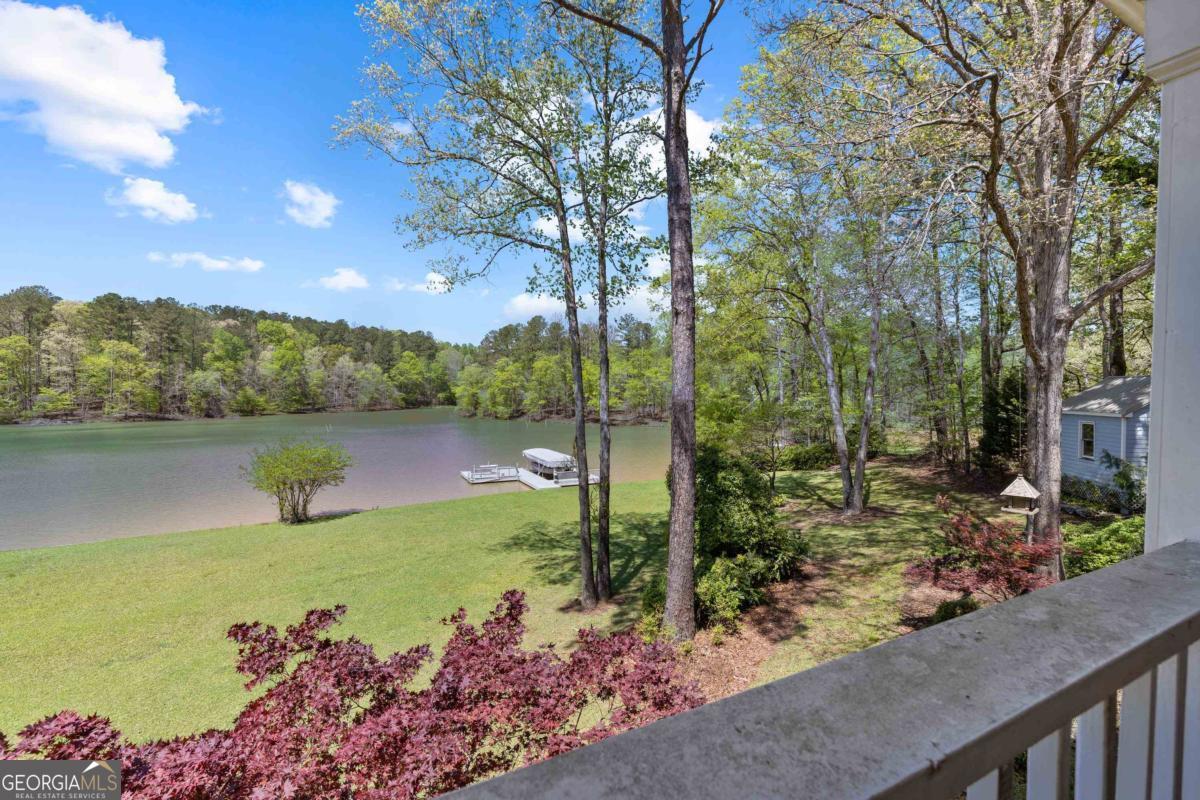 1320 Tal Lewis Road White Plains, GA 30678 - Photo 17 of 19 a view of a lake with a garden