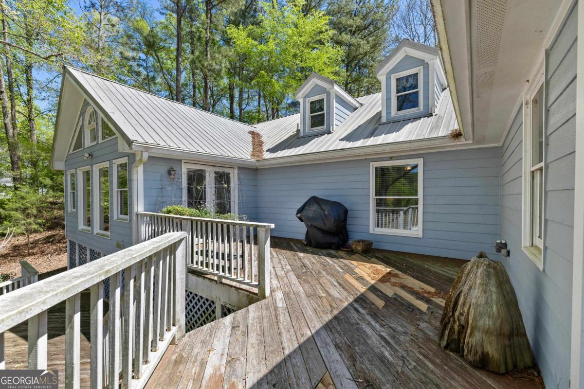 1320 Tal Lewis Road White Plains, GA 30678 - Photo 18 of 19 a view of house with a patio and wooden fence