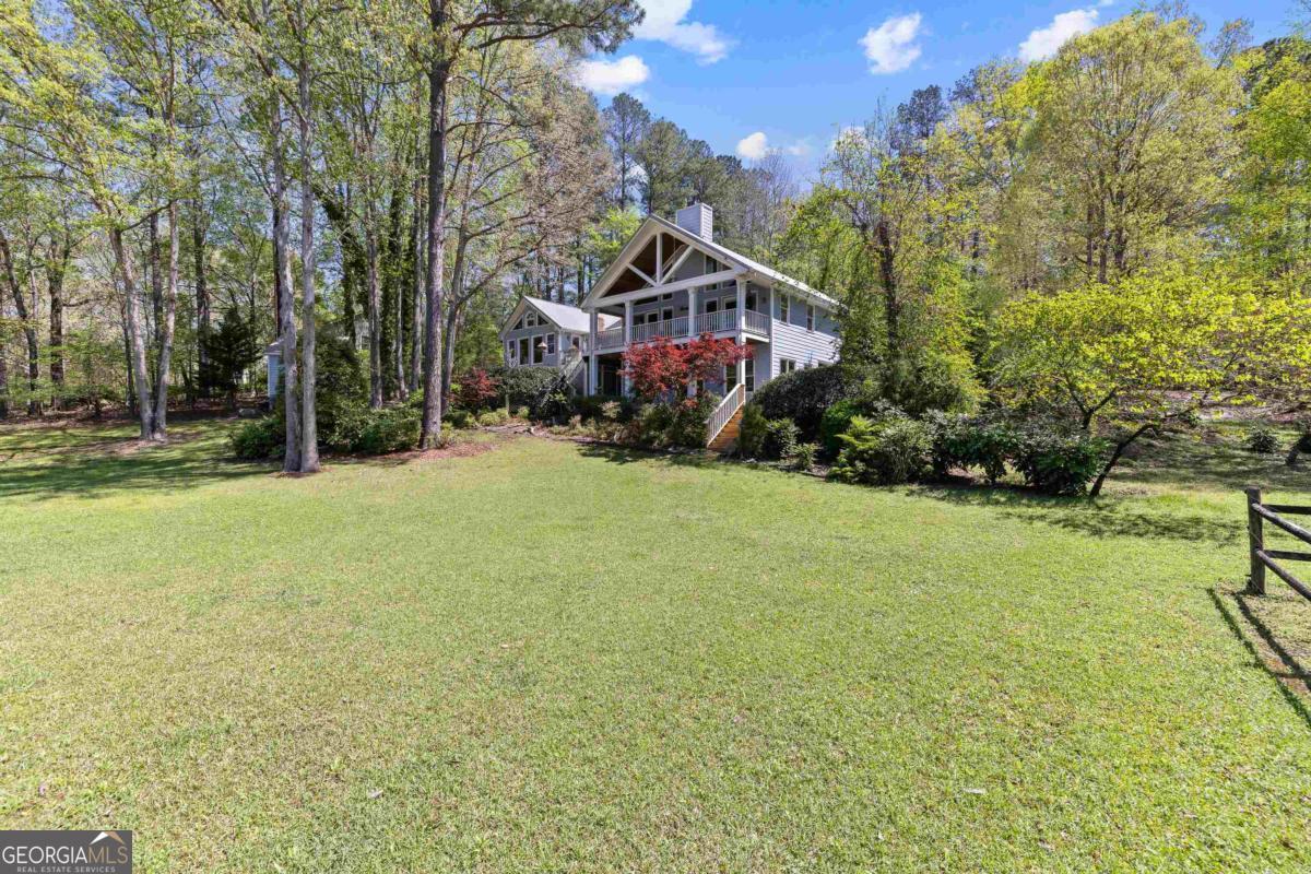 1320 Tal Lewis Road White Plains, GA 30678 - Photo 3 of 19 a view of a house with a yard and garage