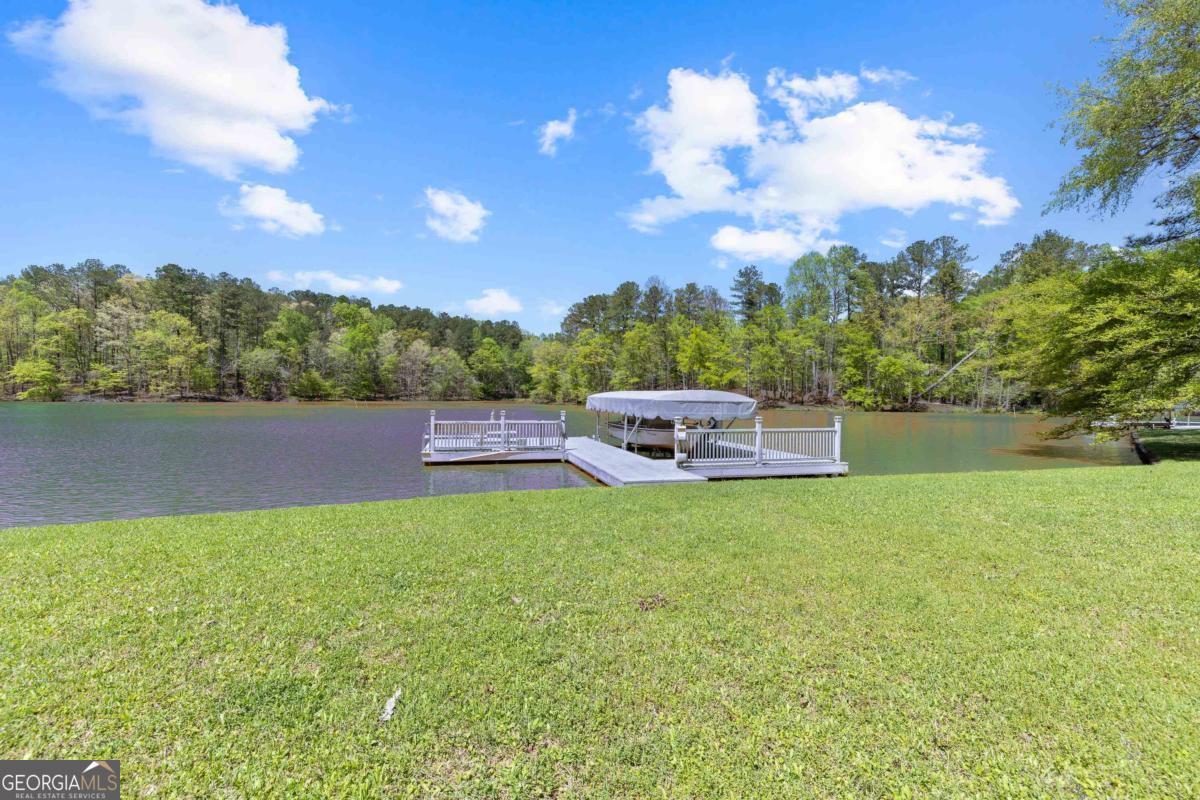 1320 Tal Lewis Road White Plains, GA 30678 - Photo 5 of 19 a backyard of a house with table and chairs