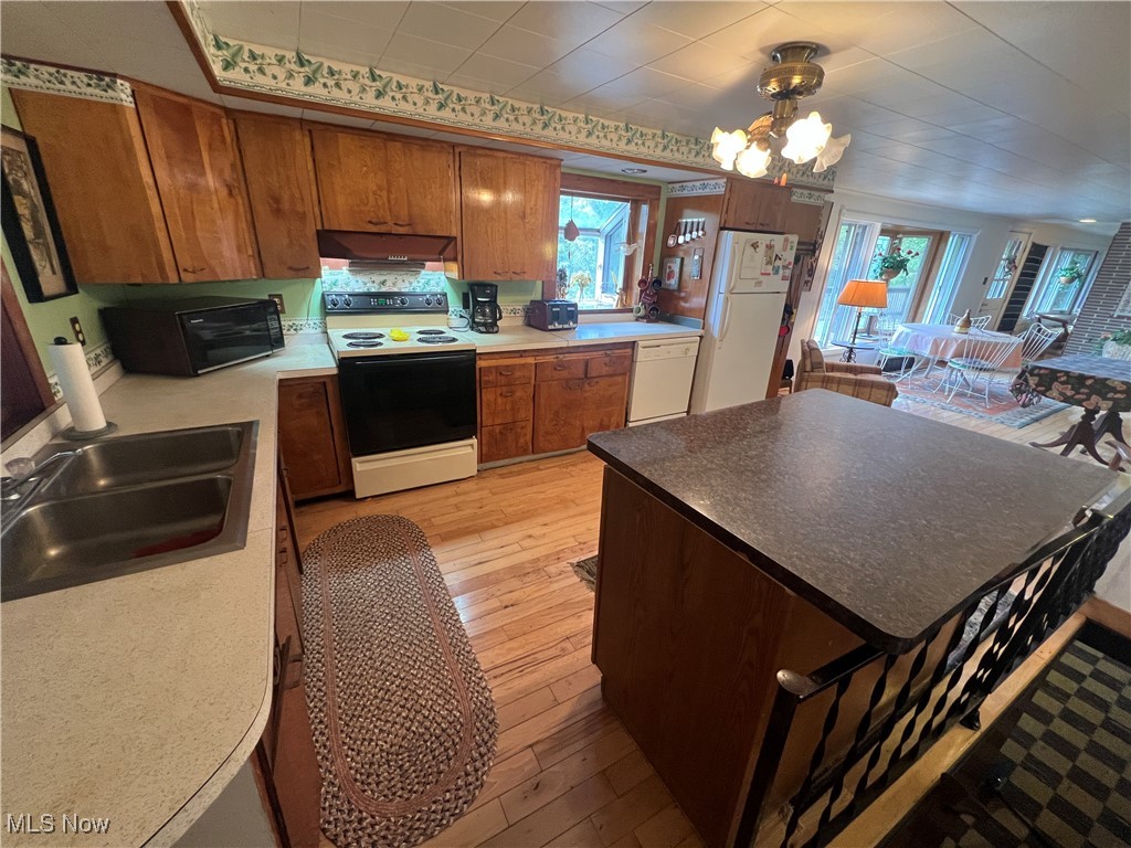 86610 Beaver Dam Road Scio, OH 43988 - Photo 17 of 50 Kitchen with white appliances, an inviting chandelier, light hardwood / wood-style floors, and sink