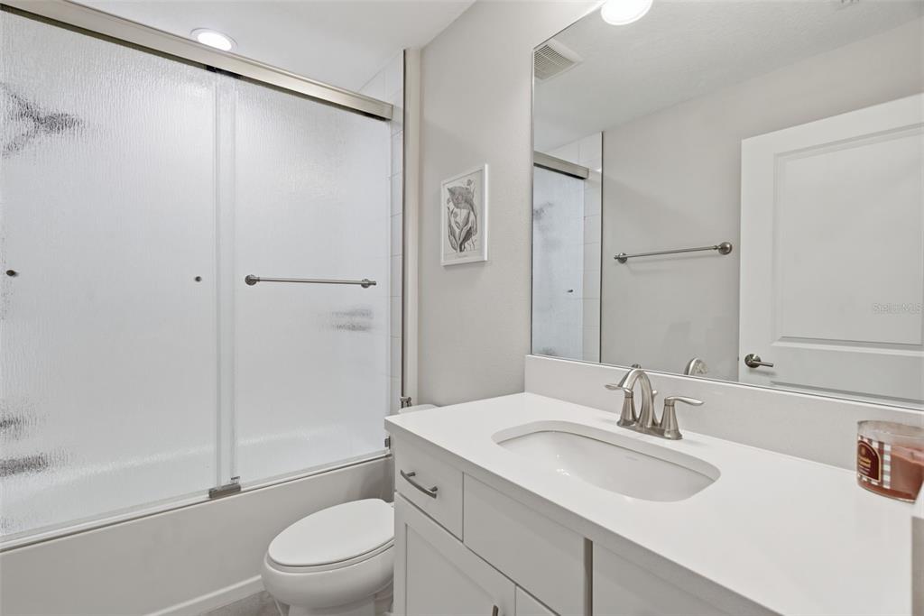 12970 Steed Trce Loop Lithia, FL 33547 - Photo 44 of 57 a bathroom with a sink toilet vanity and shower
