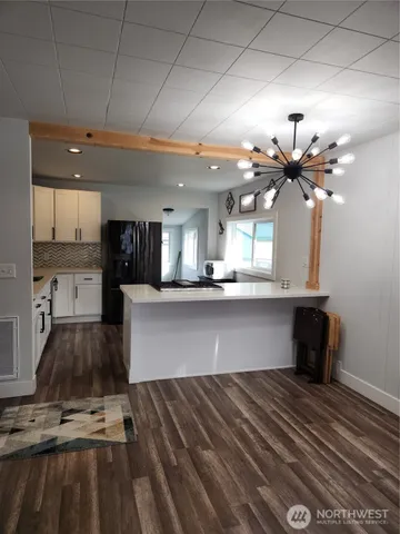 a view of kitchen with sink and wooden floor