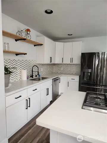 a kitchen with a refrigerator stove and sink