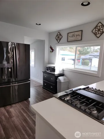 a bedroom with a bed and a flat tv screen on dresser