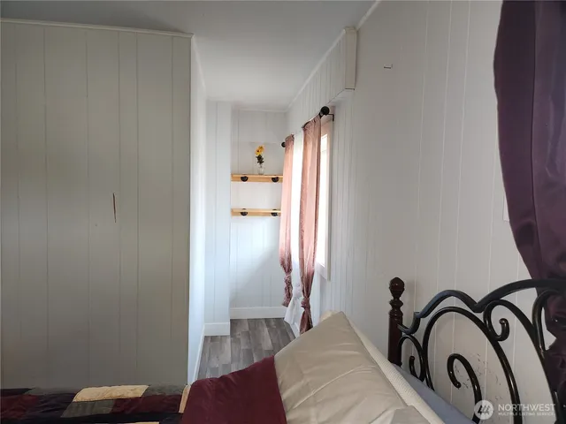 a room with a bed and a rug