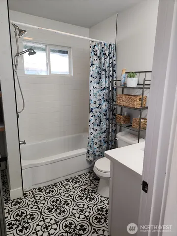 a bathroom with a bathtub and shower