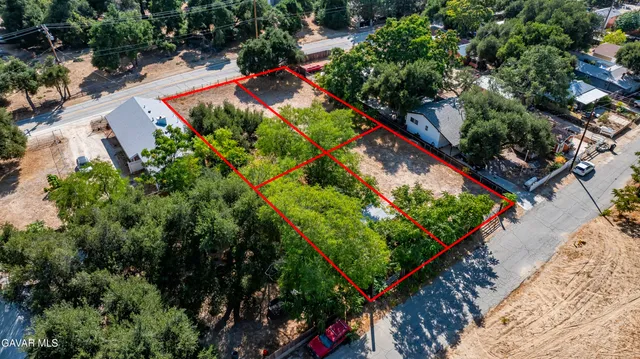 an aerial view of a house with a yard