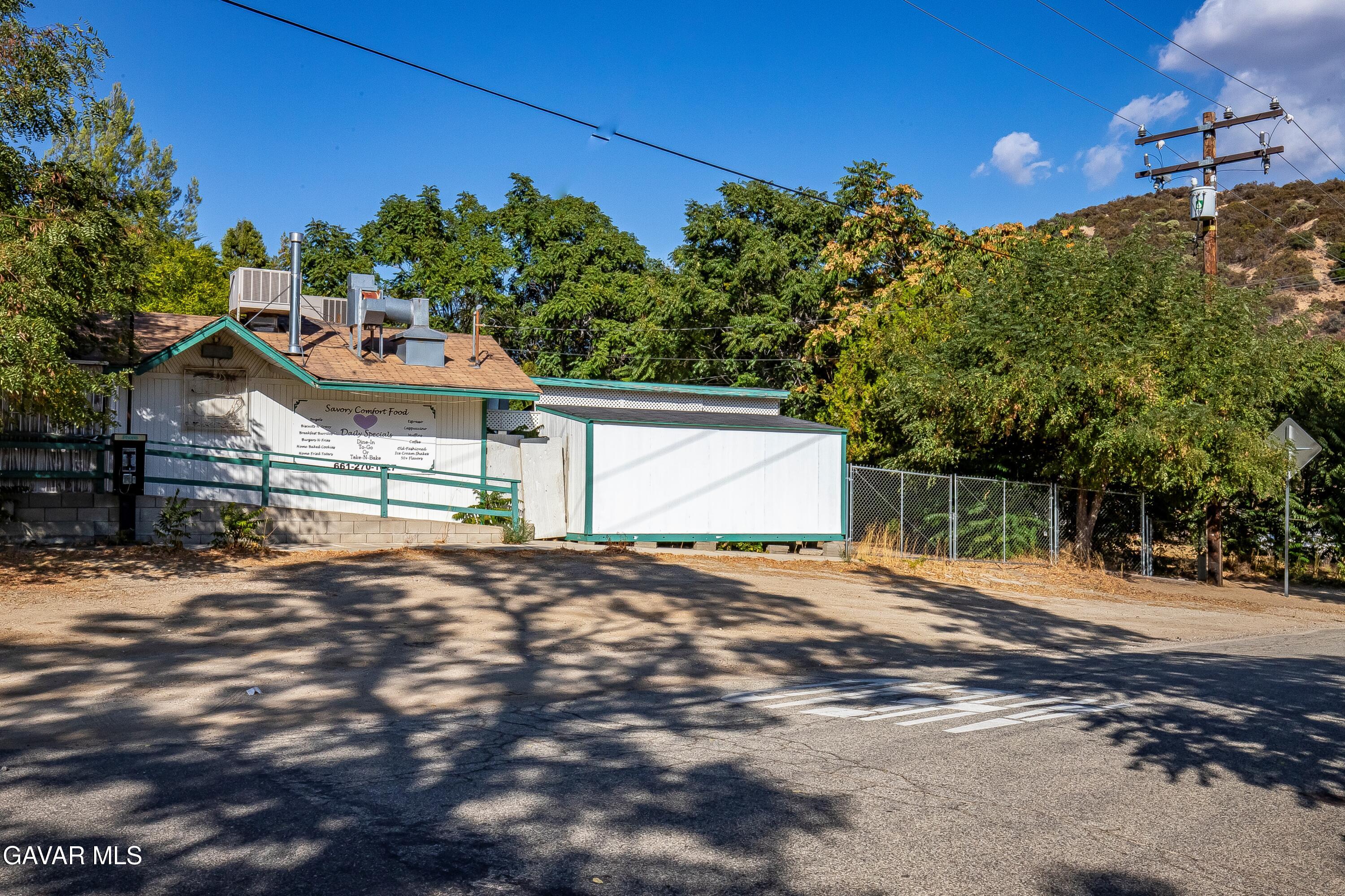 Spunky Canyon Rd Green Valley Green Valley, CA 91390 - Photo 44 of 46 a backyard of a house with table and chairs under an umbrella