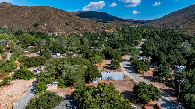 a view of a garden with a house