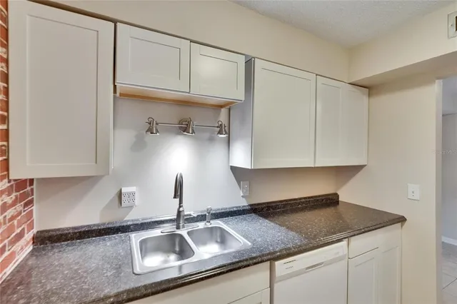 a bathroom with a sink a toilet a mirror a vanity and shower