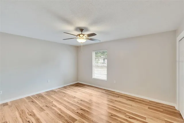 a view of a room with a ceiling fan