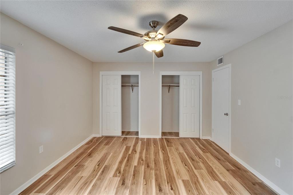 125 Picardy Villa Circle, Unit 100 Brandon, FL 33510 - Photo 23 of 52 a view of a bedroom with a bed and a chandelier