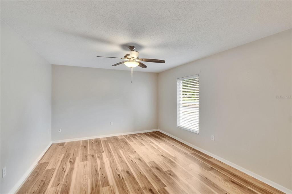 125 Picardy Villa Circle, Unit 100 Brandon, FL 33510 - Photo 26 of 52 wooden floor in an empty room with a window