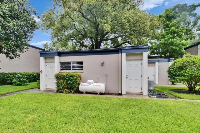 an aerial view of a house with a garden and trees