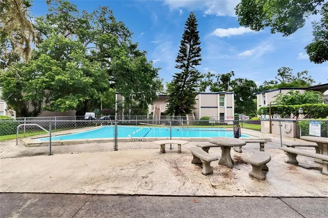 an aerial view of a house with a yard and swimming pool