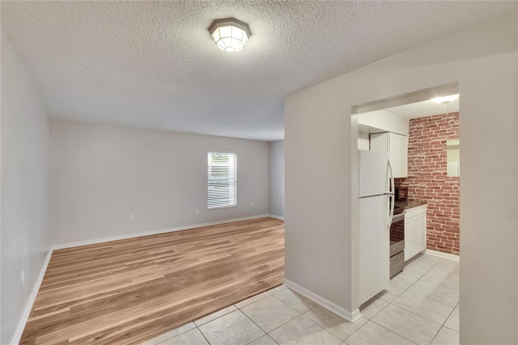 125 Picardy Villa Circle, Unit 100 Brandon, FL 33510 - Photo 4 of 52 a view of empty room with kitchen and window