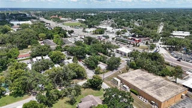 an aerial view of a house with a yard and lake view