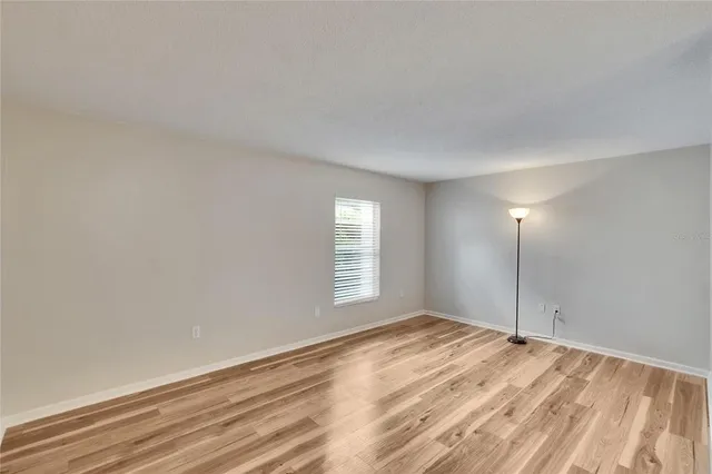 a view of an empty room and wooden floor