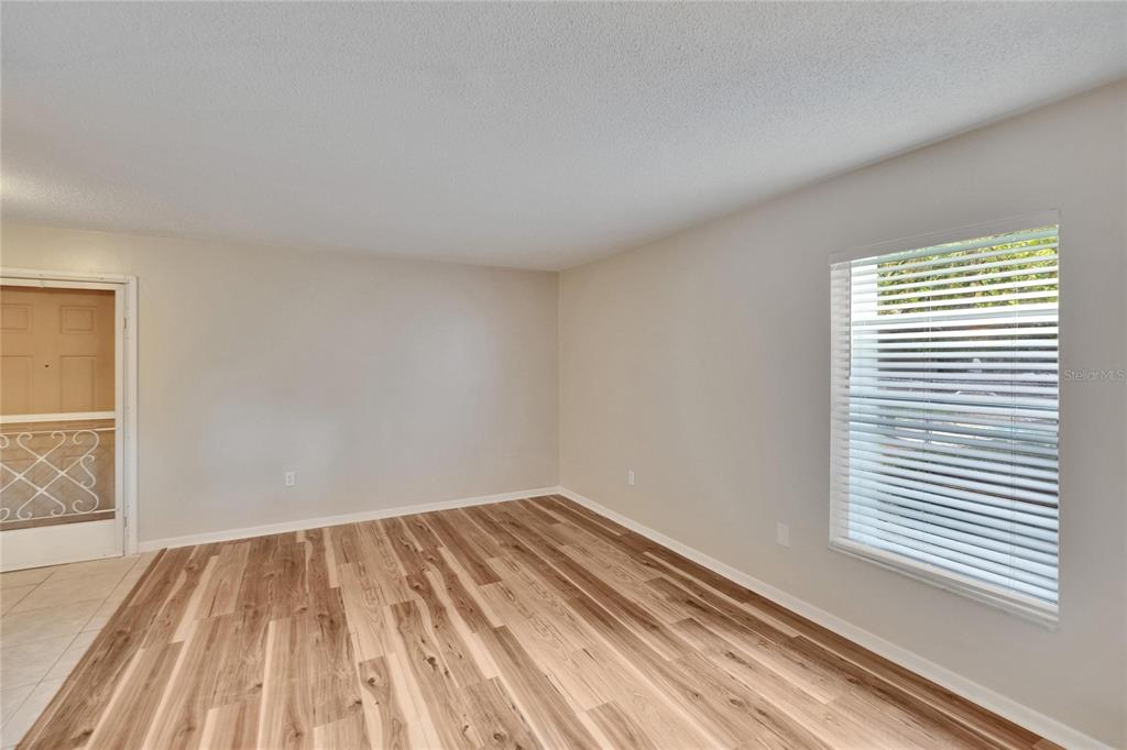 125 Picardy Villa Circle, Unit 100 Brandon, FL 33510 - Photo 9 of 52 a view of a room with wooden floor and a window