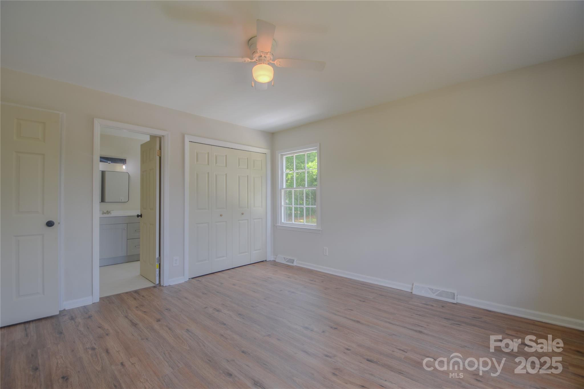 6921 Idlewild Road Charlotte, NC 28212 - Photo 11 of 29 a view of an empty room with wooden floor and window