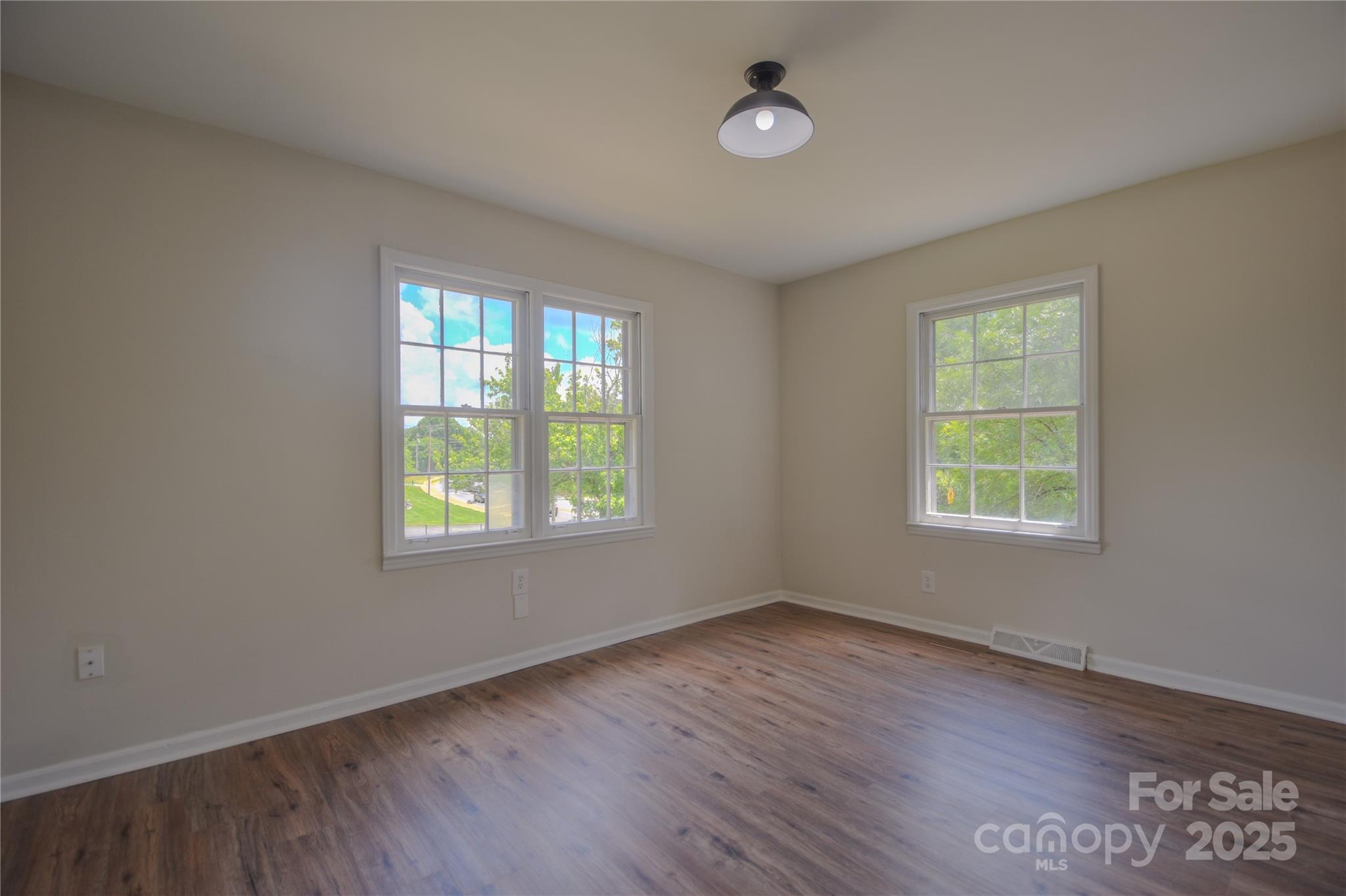 6921 Idlewild Road Charlotte, NC 28212 - Photo 16 of 29 a view of an empty room with wooden floor and a window