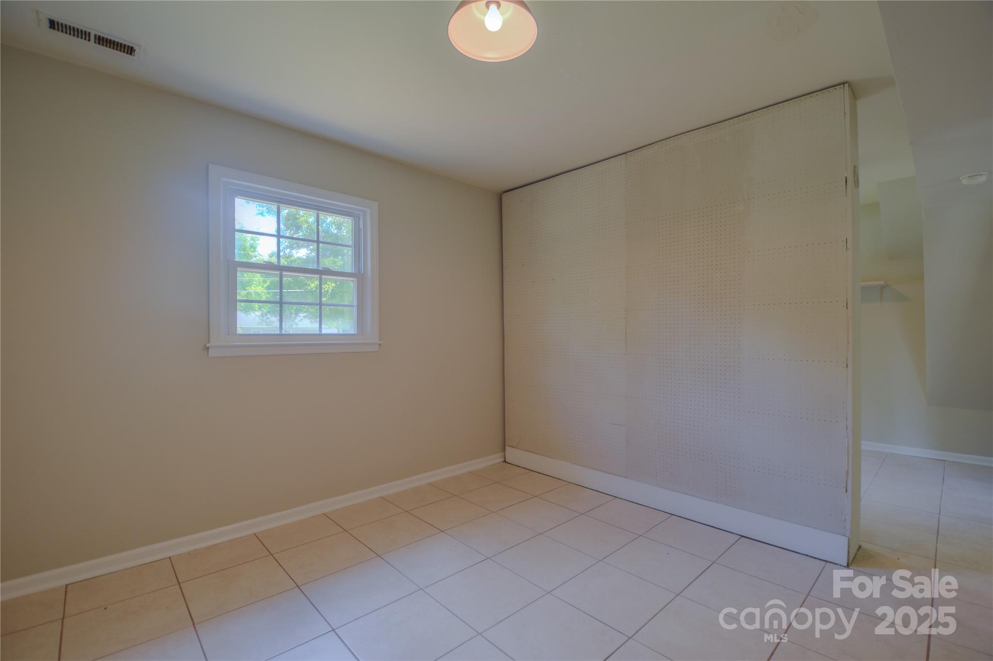 6921 Idlewild Road Charlotte, NC 28212 - Photo 19 of 29 a view of an empty room with a window