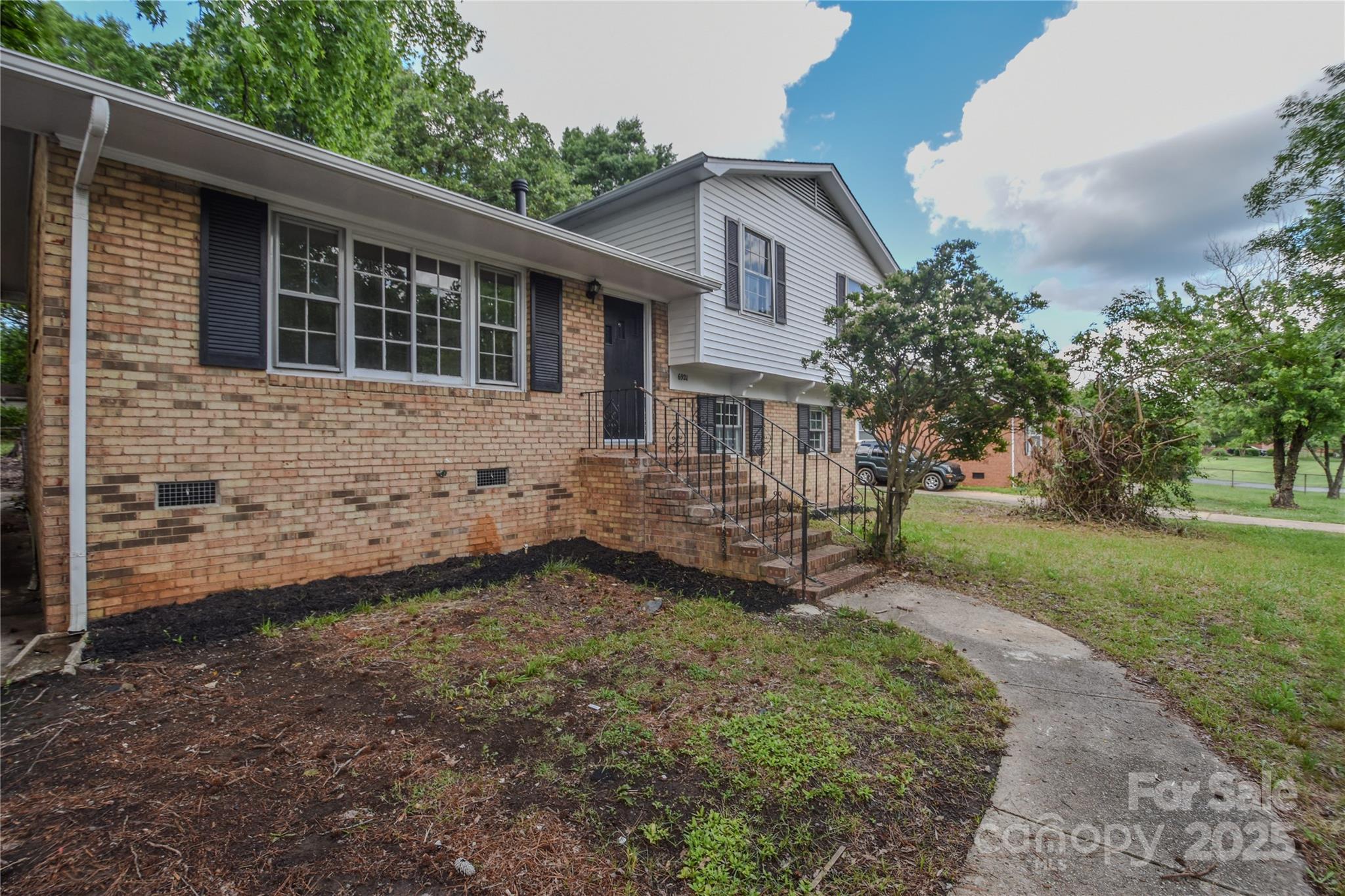 6921 Idlewild Road Charlotte, NC 28212 - Photo 2 of 29 a view of a house with a yard and sitting area